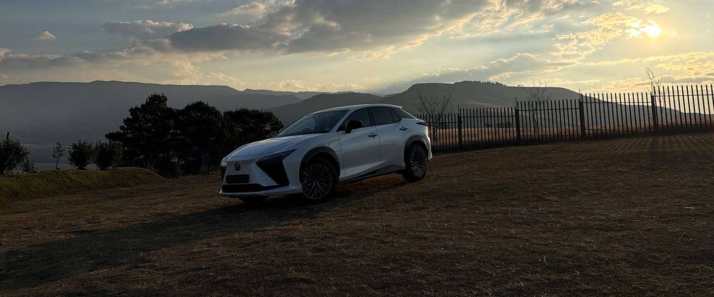 White Lexus RZ parked in the Drakensberg at sunset