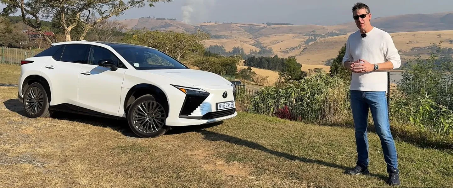 Greg Cress standing beside the white Lexus RZ during a road trip