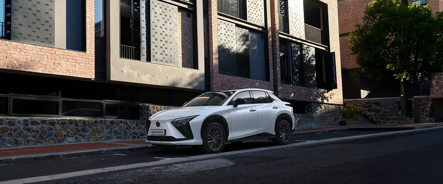 The white Lexus RZ parked on a city street